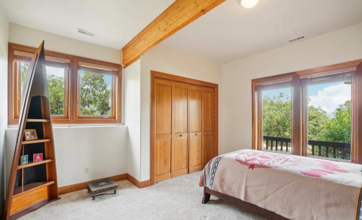 Bedroom with carpet flooring and glass doors.