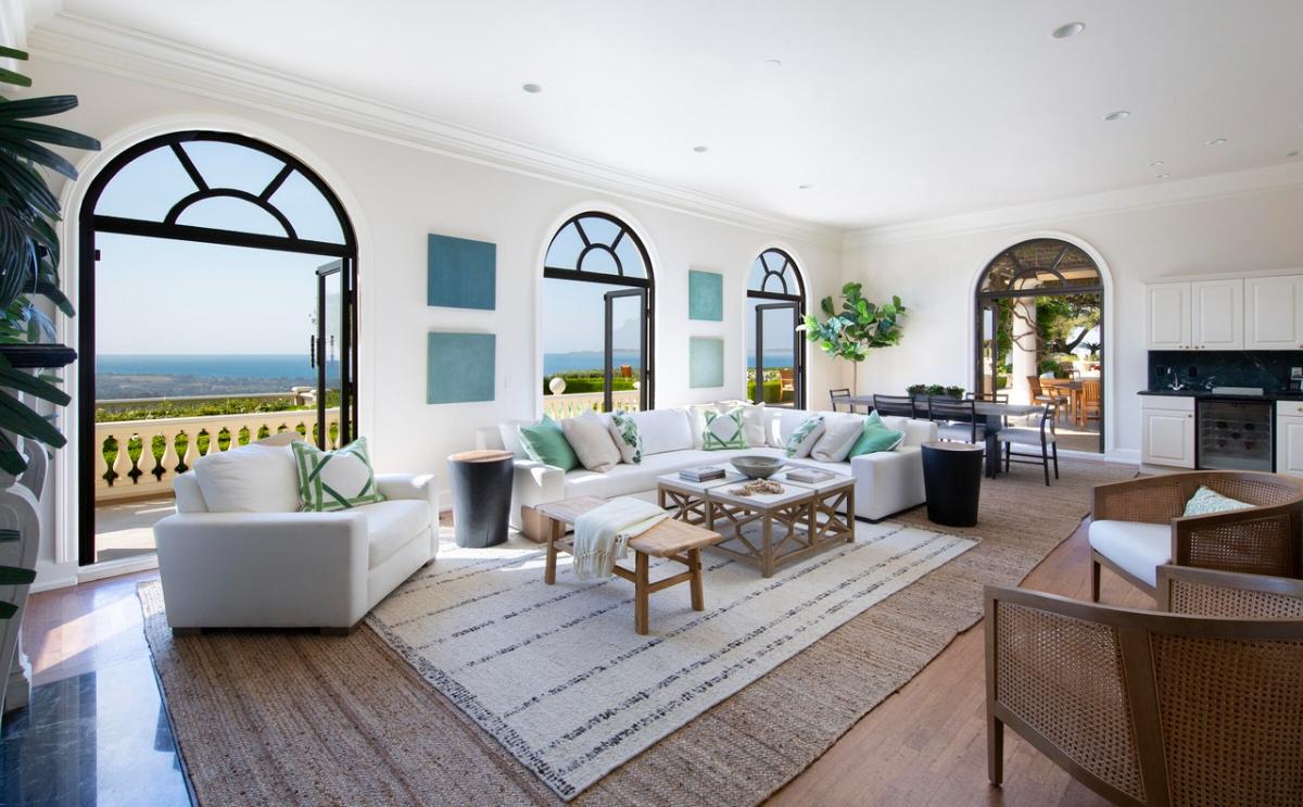 Living room with couches and glass doors.