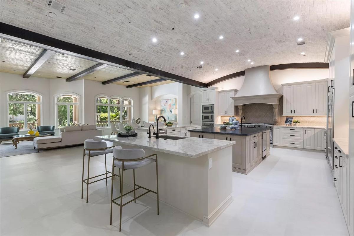 Kitchen with custom cabinetry, counter breakfast bar and a center island prep area.