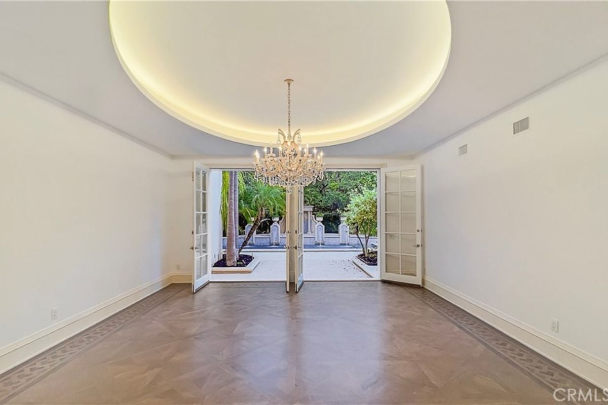 An empty room with chandelier.