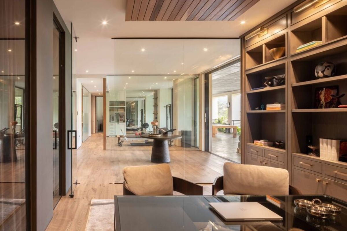 A home office with a shelf, a cabinet, a desk, and chairs.