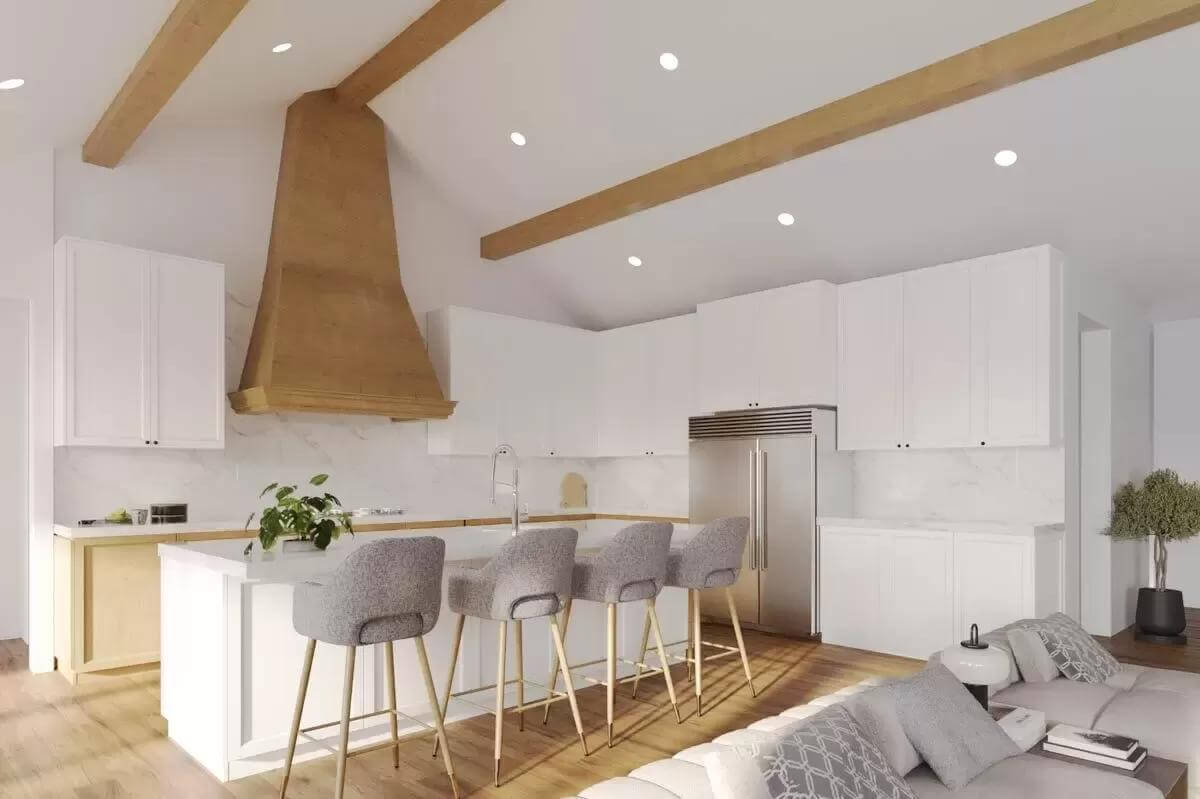 Kitchen with white cabinetry, a matching island, and a cathedral ceiling lined by exposed beams.