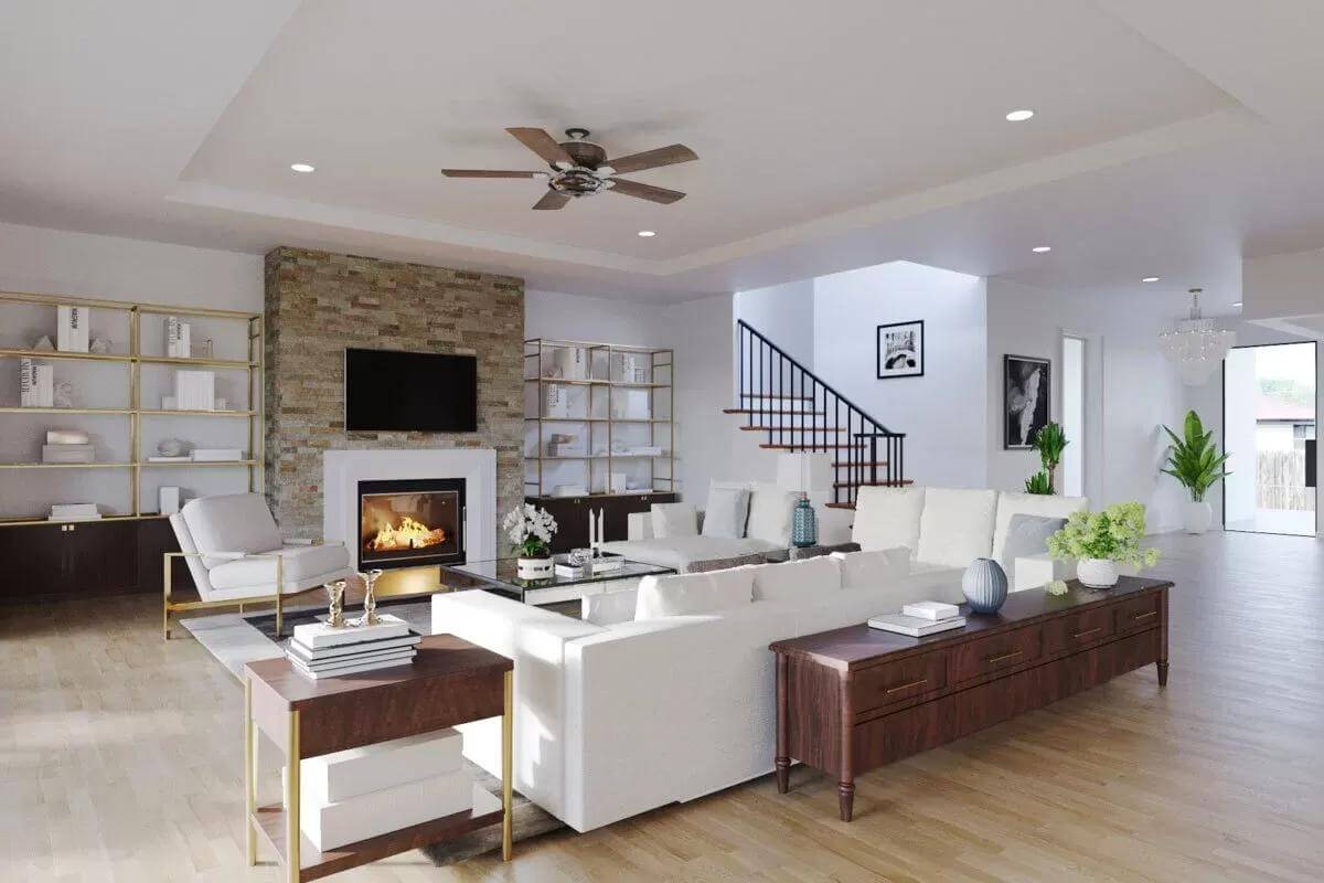 Great room with white seats and a fireplace flanked by shelving units.