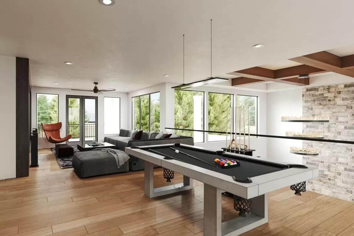Recreation room with a billiards table and an L-shaped sofa.