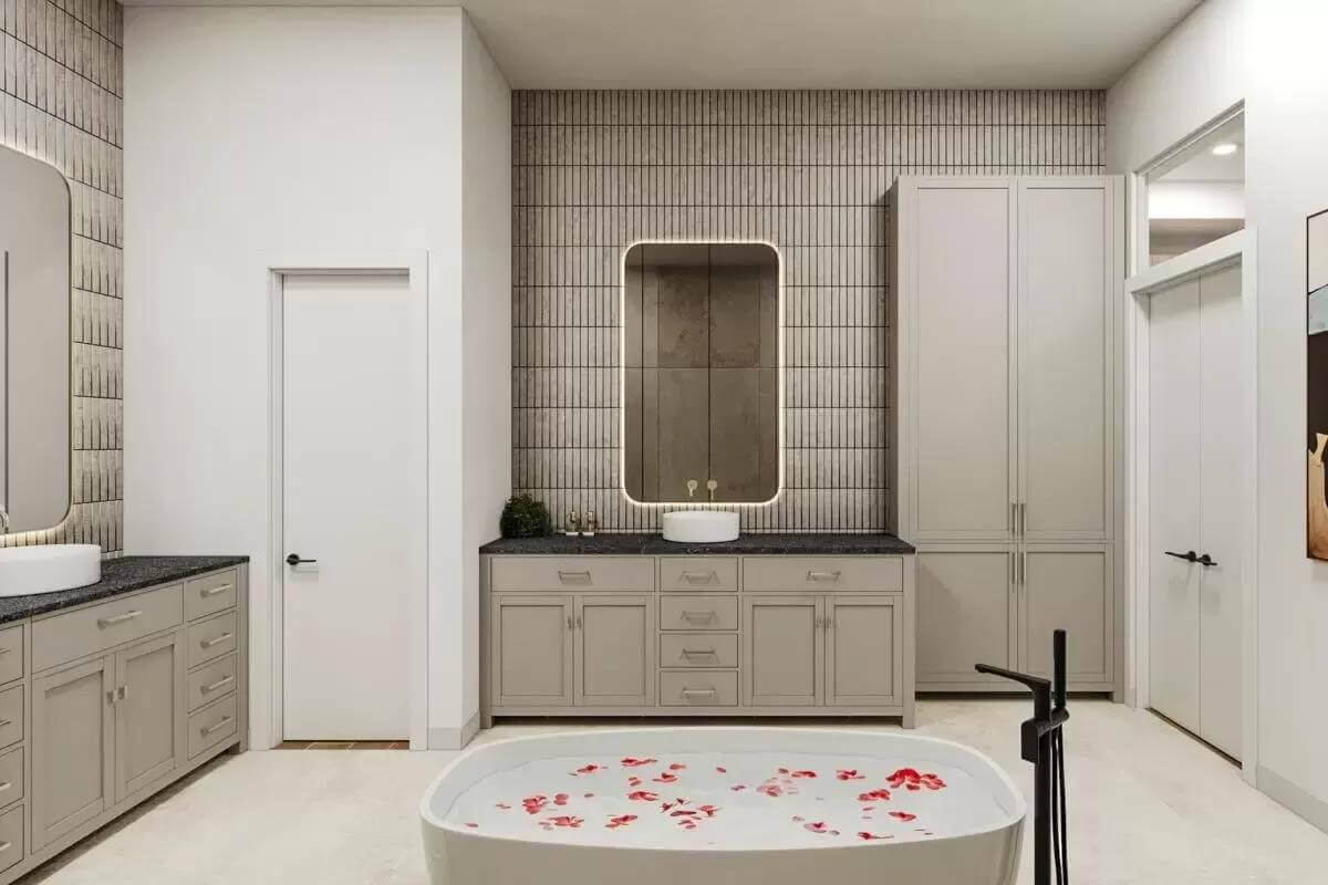 Primary bathroom with his and her vanities, a linen closet, and a soaking tub.