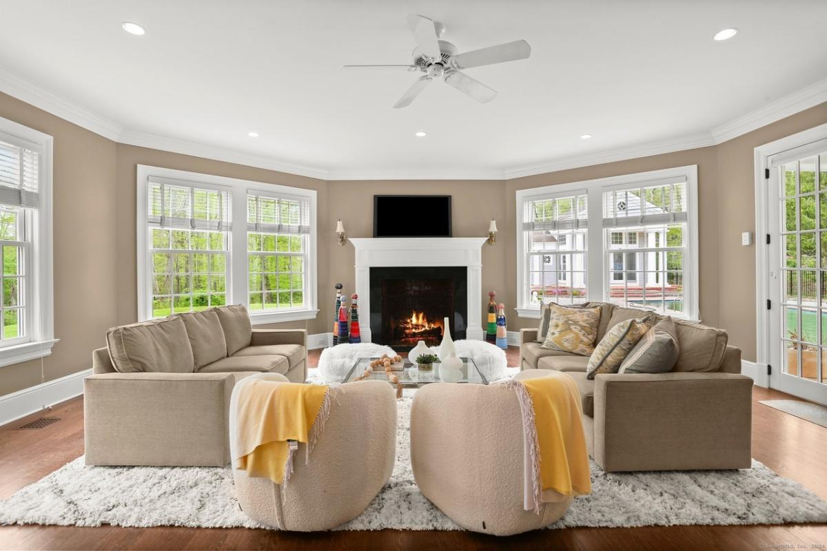 Living room with couches and a fireplace.