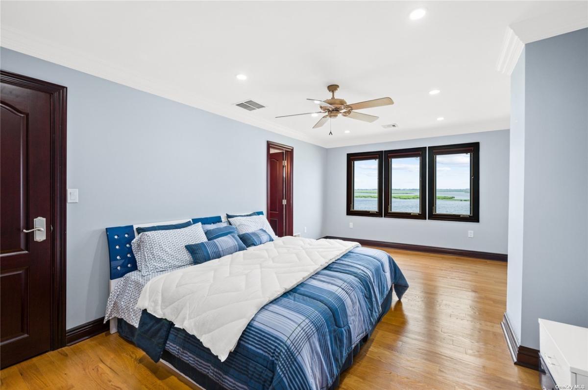 Bedroom with hardwood floors and glass windows.