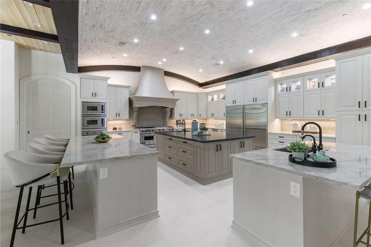 Kitchen with custom cabinetry, counter breakfast bar and a center island prep area.
