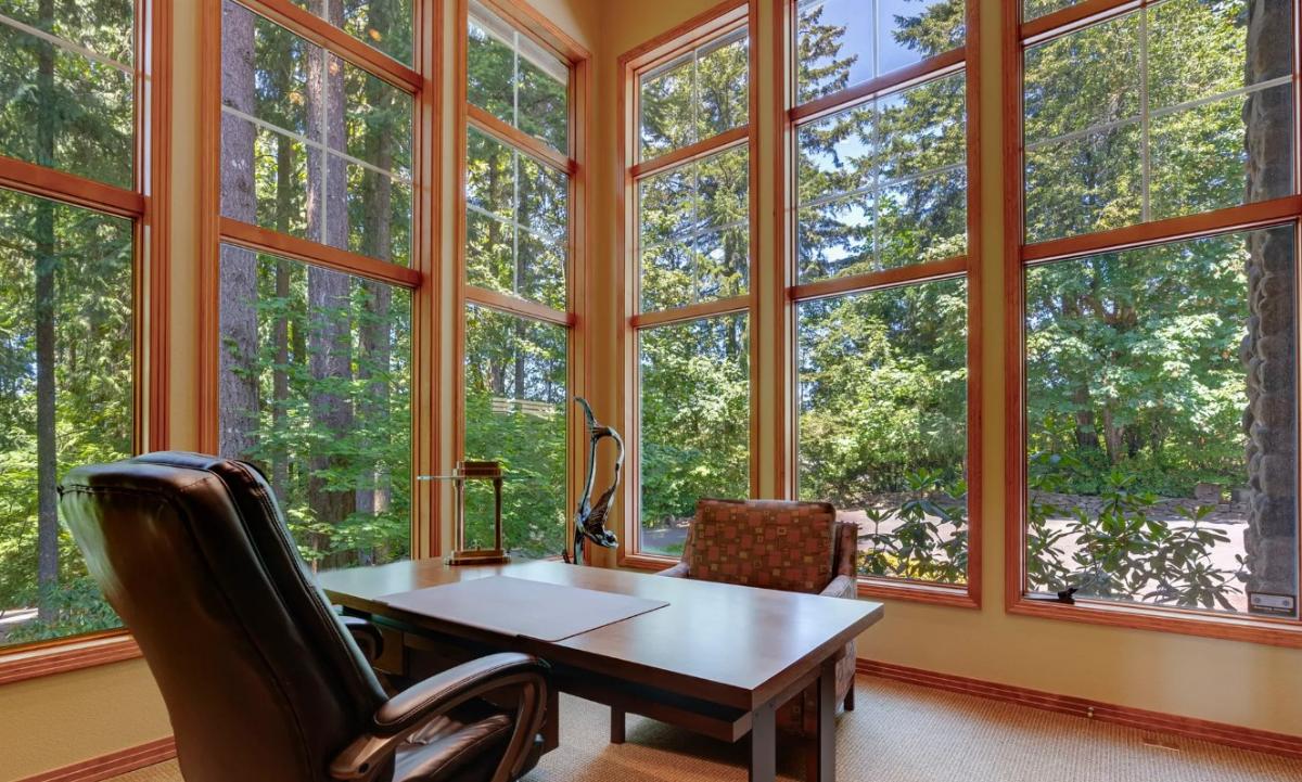 Home office with floor-to-ceiling windows.
