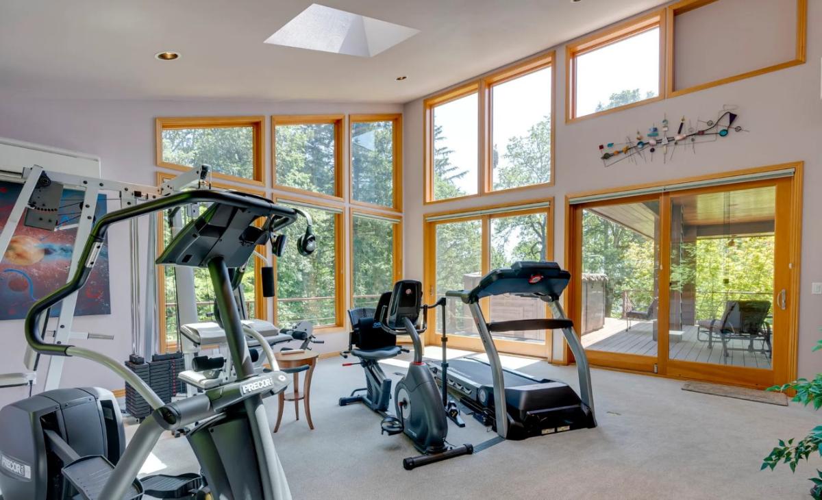 Home gym with floor-to-ceiling windows.