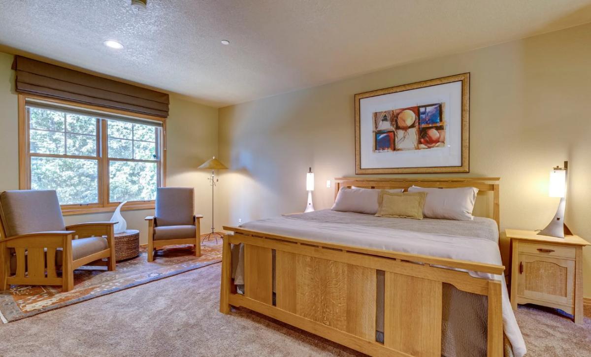 Bedroom with a large bed and carpet flooring.