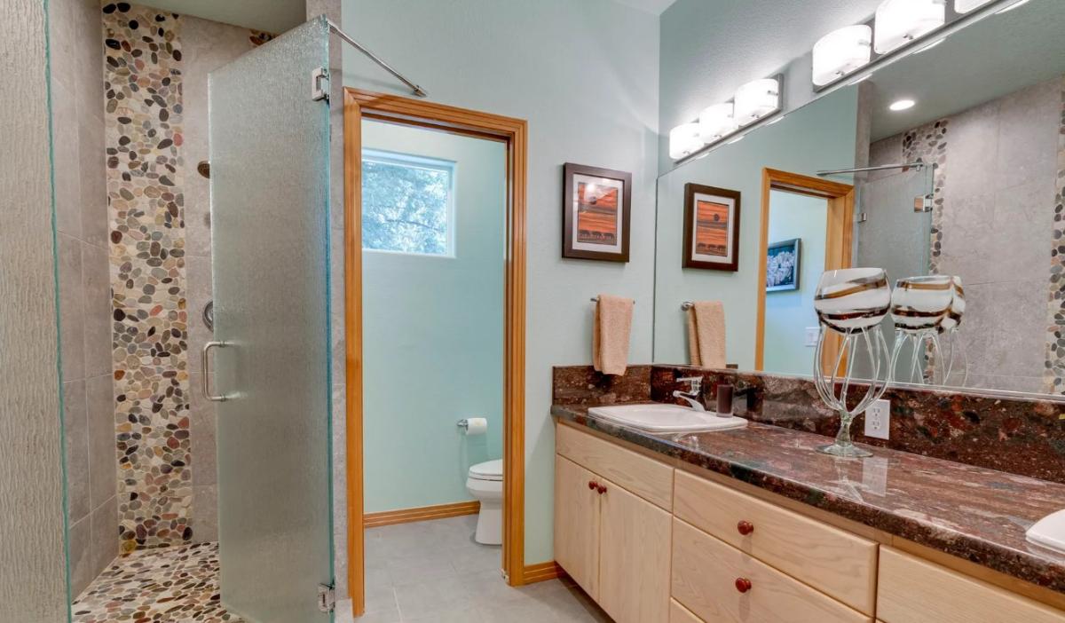 Bathroom with a sink, toilet and a walk-in shower.