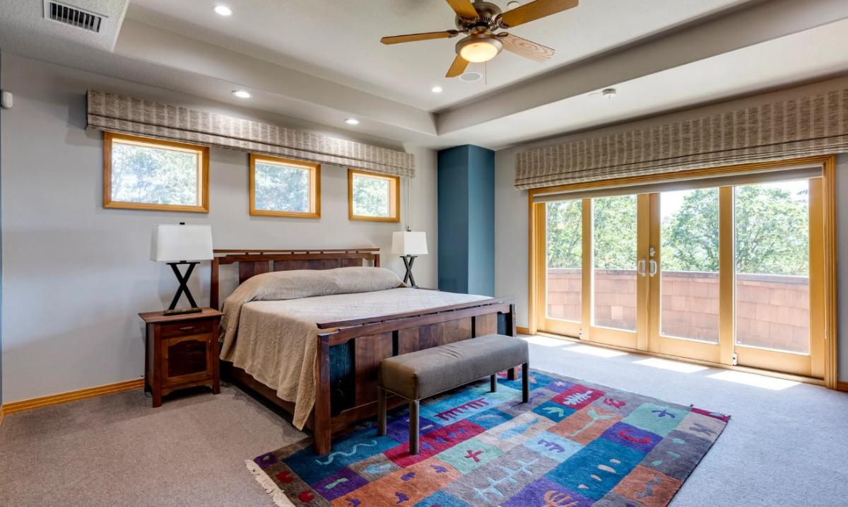 Bedroom with a large bed and carpet flooring.