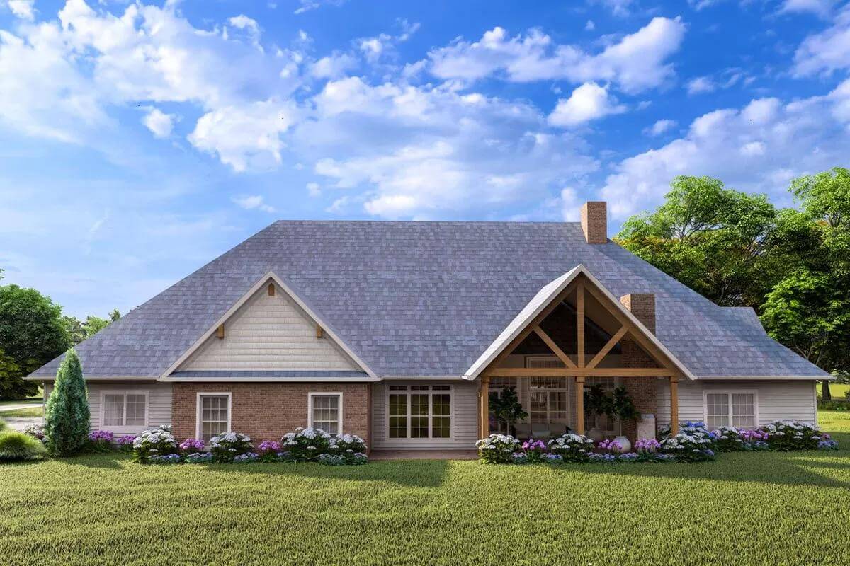 Rear view with mixed sidings and a gabled porch framed by timber beams.