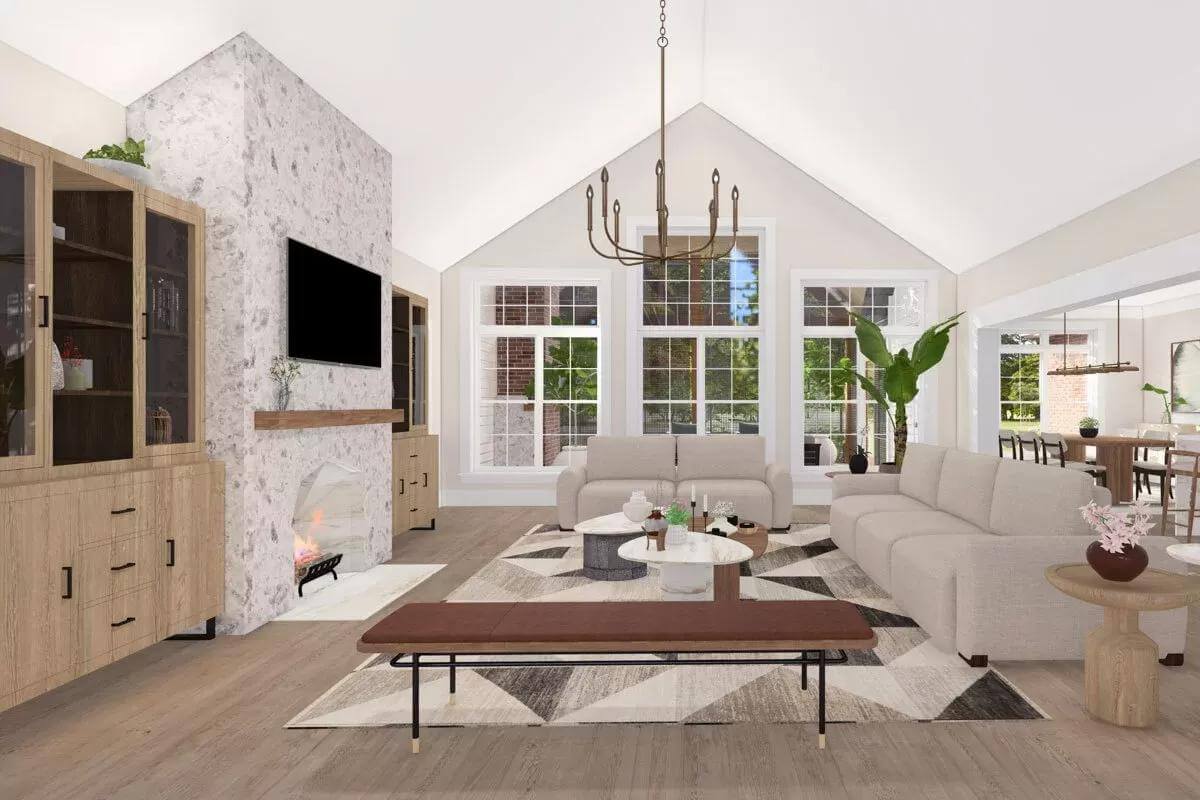 Great room with modern sofas, nesting coffee tables, and a fireplace under a cathedral ceiling.