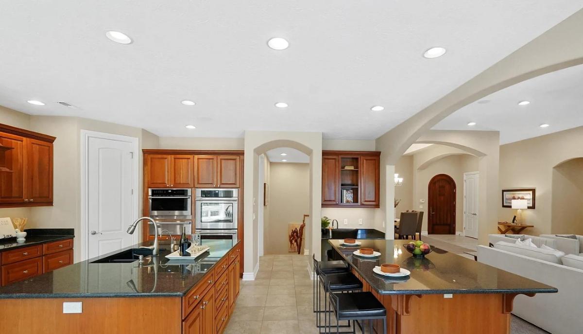 Kitchen with custom cabinetry, a counter breakfast bar and a center island prep area.
