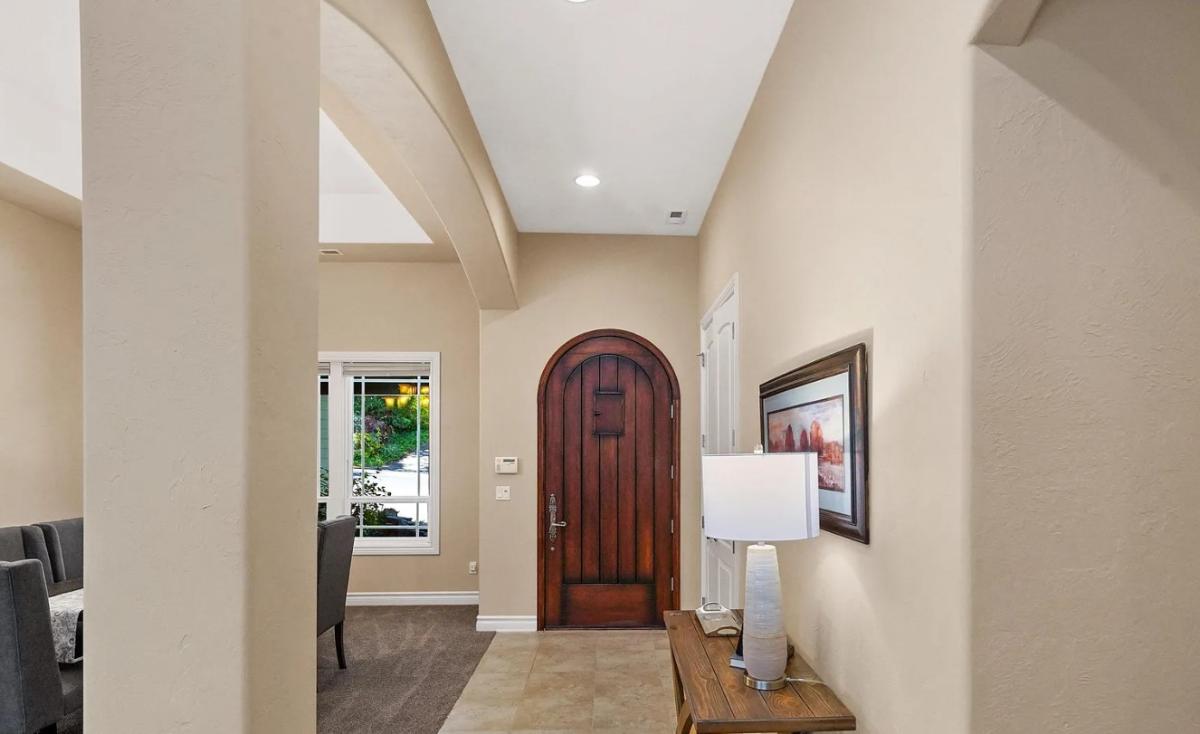 Foyer with a hardwood door.