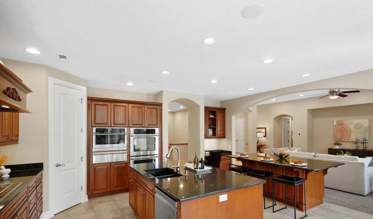 Kitchen with custom cabinetry, a counter breakfast bar and a center island prep area.