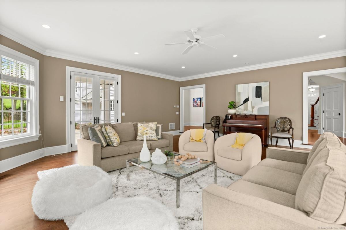 Living room with couches and a piano.