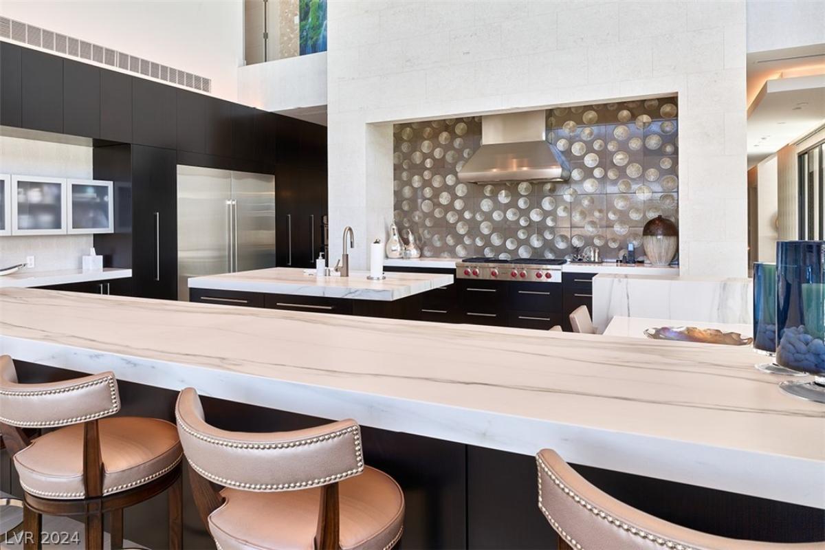 Kitchen with custom cabinetry and a counter breakfast bar.