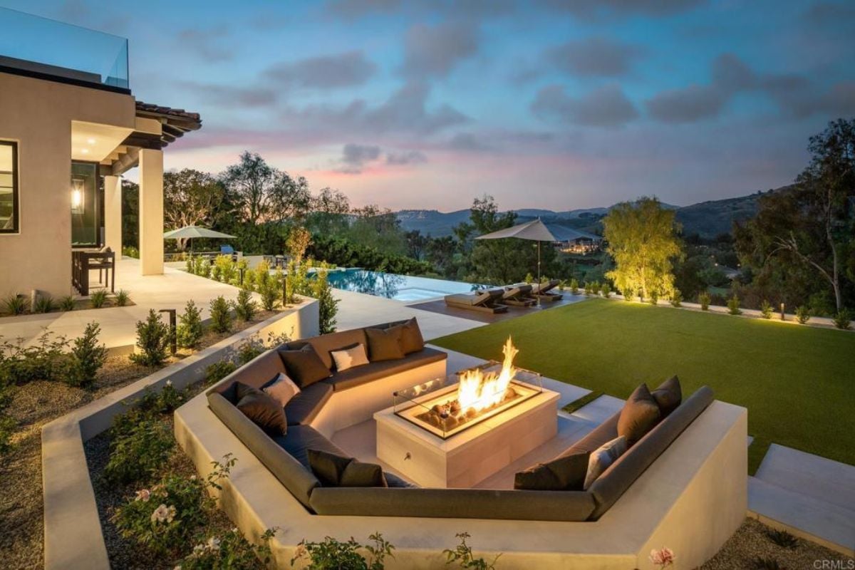 A patio with a firepit surrounded by a U-shaped bench.