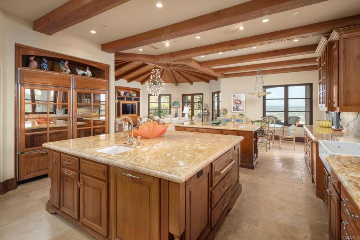 A kitchen with a center island, countertops, cabinets, and a sink.