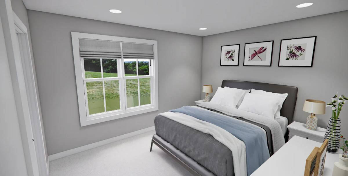 Bedroom with an upholstered bed adorned by black-framed artworks.