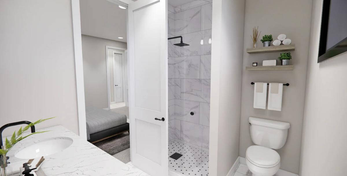 Primary bathroom with a marble-tiled shower and a toilet topped by floating shelves.