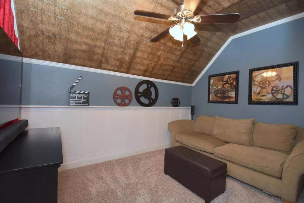 Sitting room with a TV and a sofa under the coved ceiling.