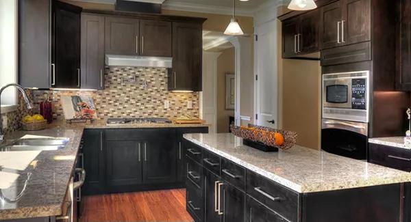 Kitchen with dark wood cabinets and a matching island.