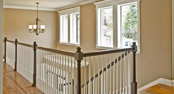 Upstairs hall with wooden railings and clerestory windows.