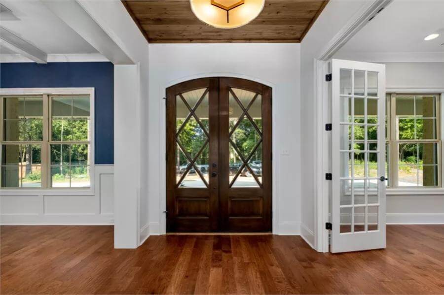 Foyer with a French front door and a wood-paneled ceiling.