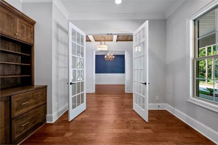 Office with a rustic cabinet and a French door.