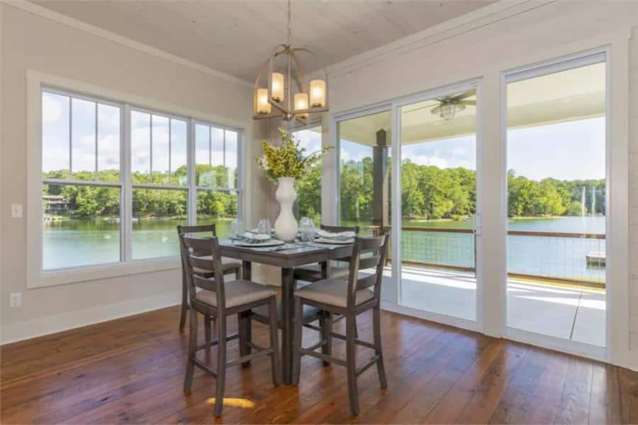 Dining area with a dark wood dining set and sliding glass doors that open to a covered porch.