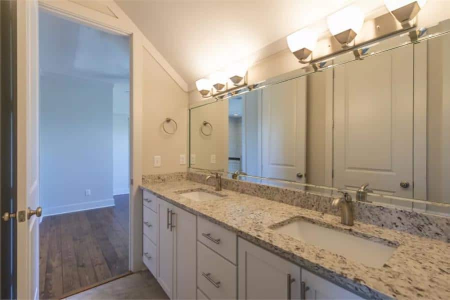 Bathroom with a dual sink vanity under the vaulted ceiling.