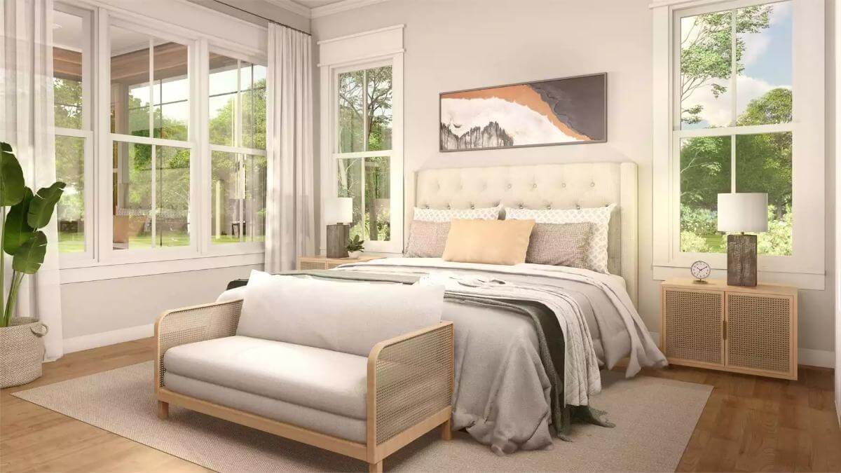 Primary bedroom with a tufted bed complemented by a rattan sofa.