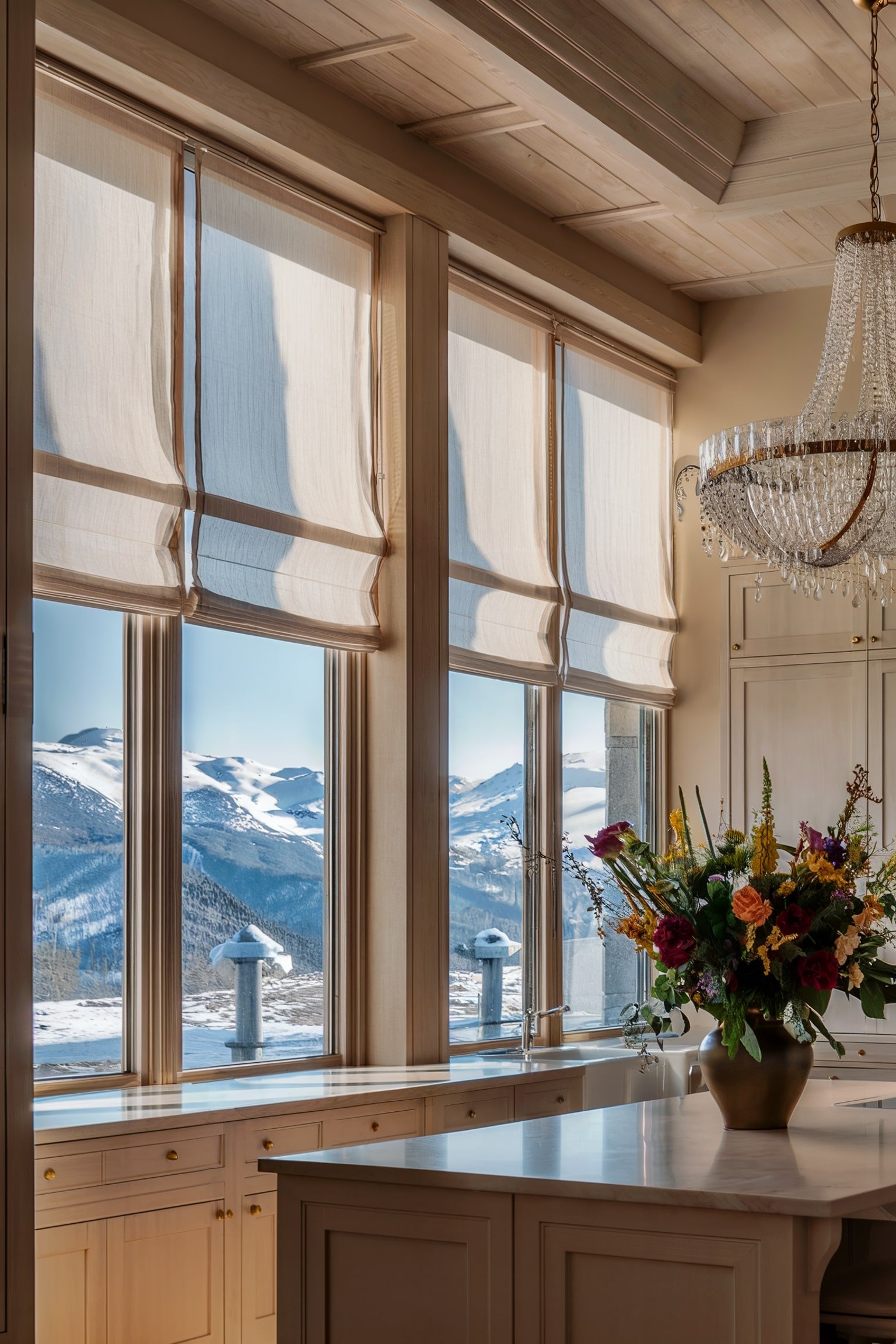 Kitchen with large windows, Roman shades, and a mountain view