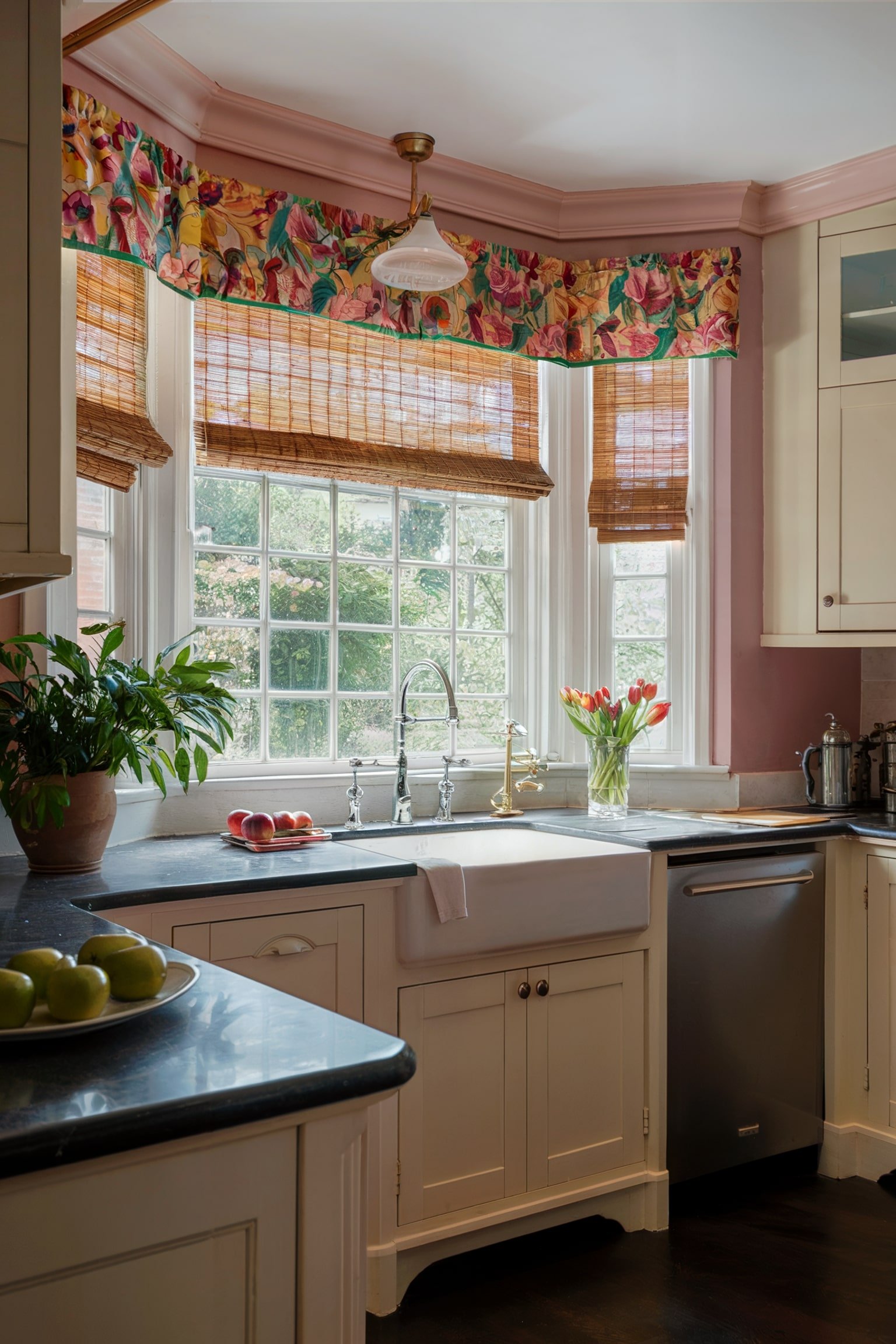 Farmhouse kitchen with a bay window, bamboo blinds, and floral valances