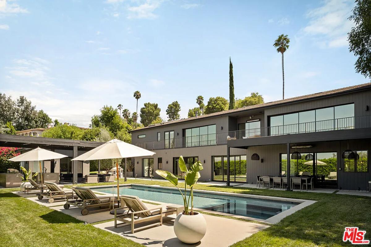 Rear view of the mansion with a pool.
