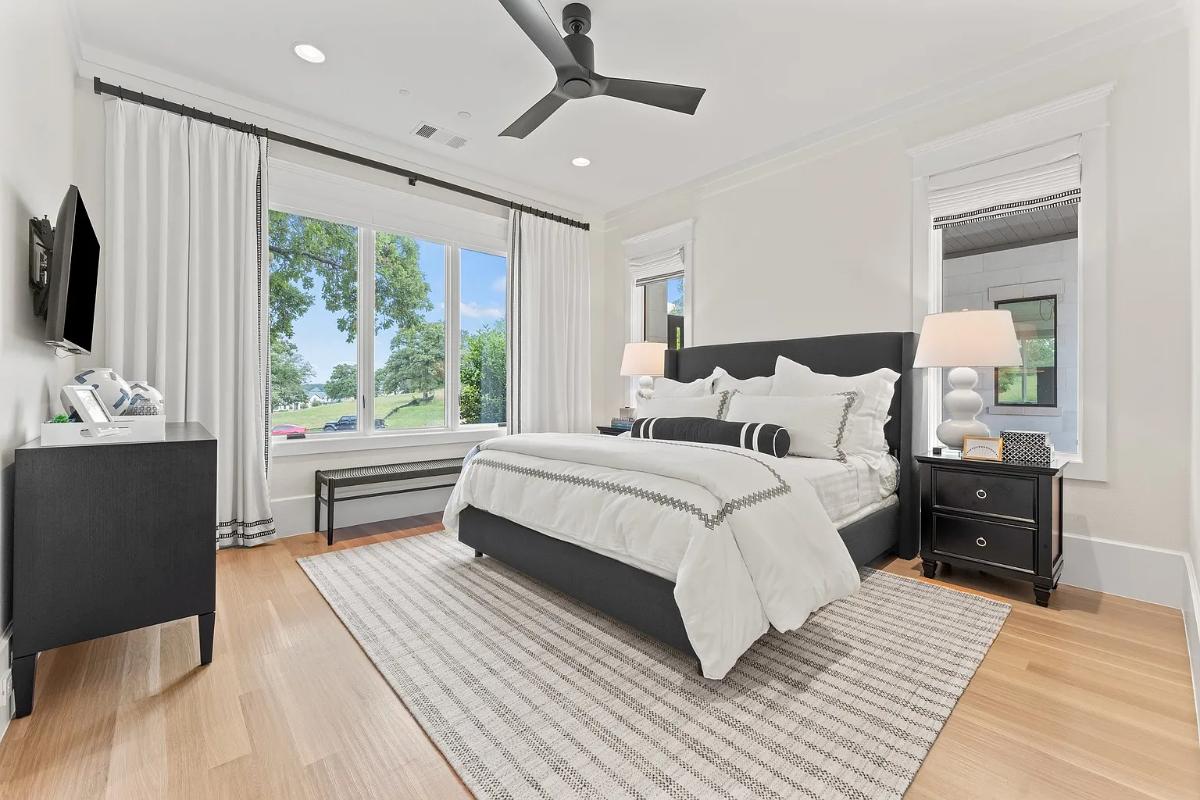 Bedroom with hardwood flooring and glass windows.