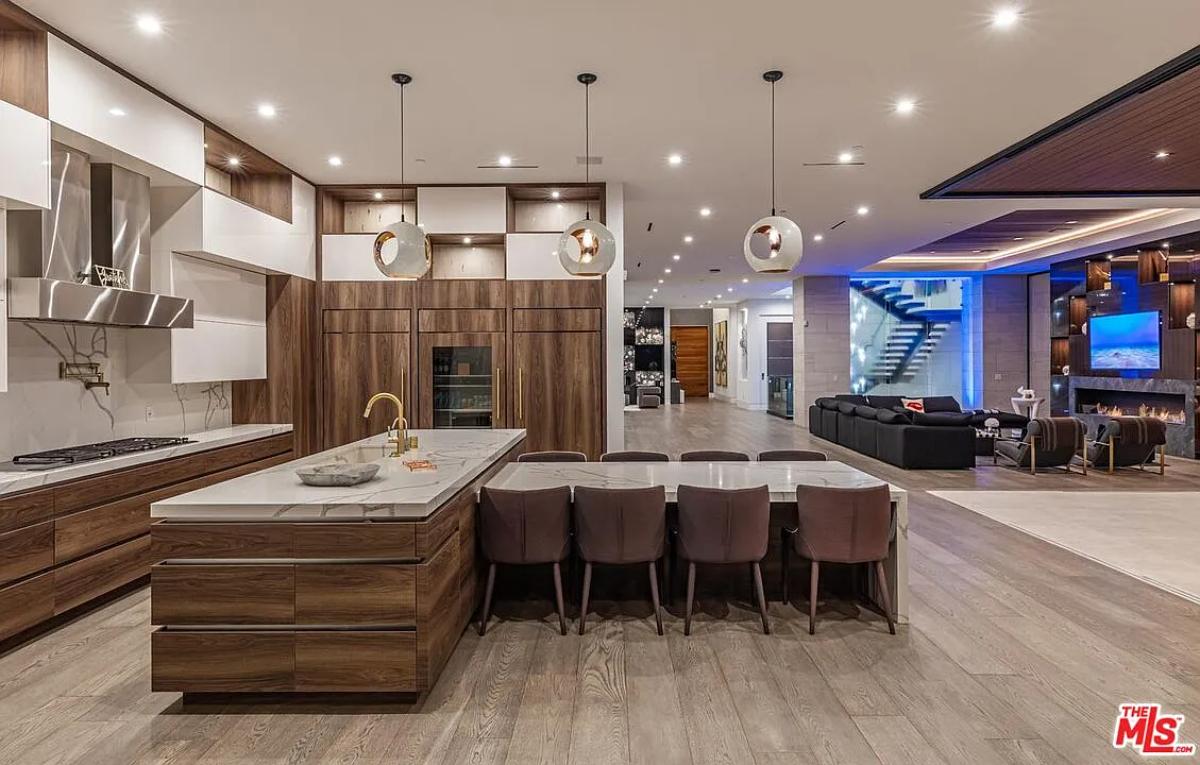 Kitchen with custom cabinetry, a counter breakfast bar and a center island prep area.