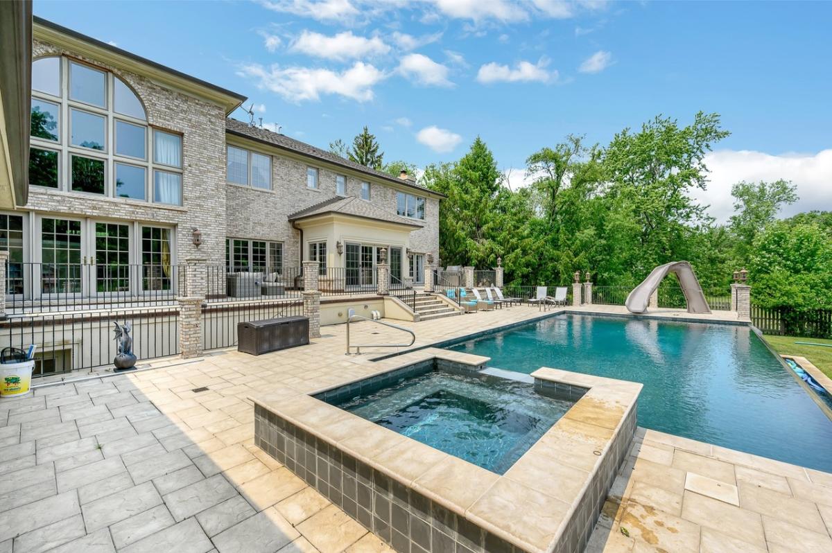 Rear view of the mansion with a pool.