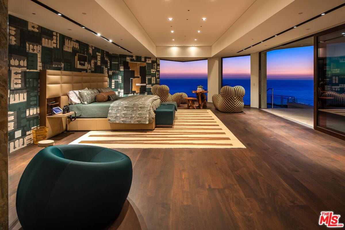 Bedroom with hardwood floors and sliding glass doors.