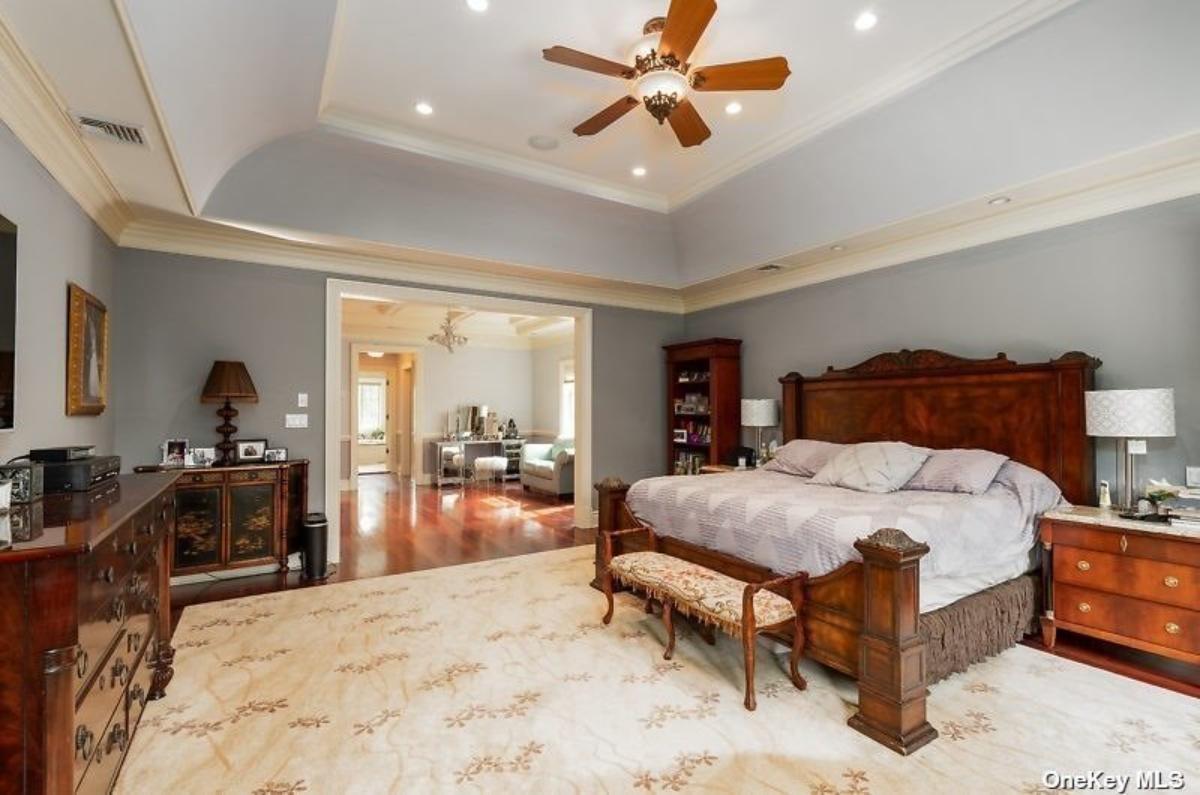 Bedroom with a large bed and hardwood floors.