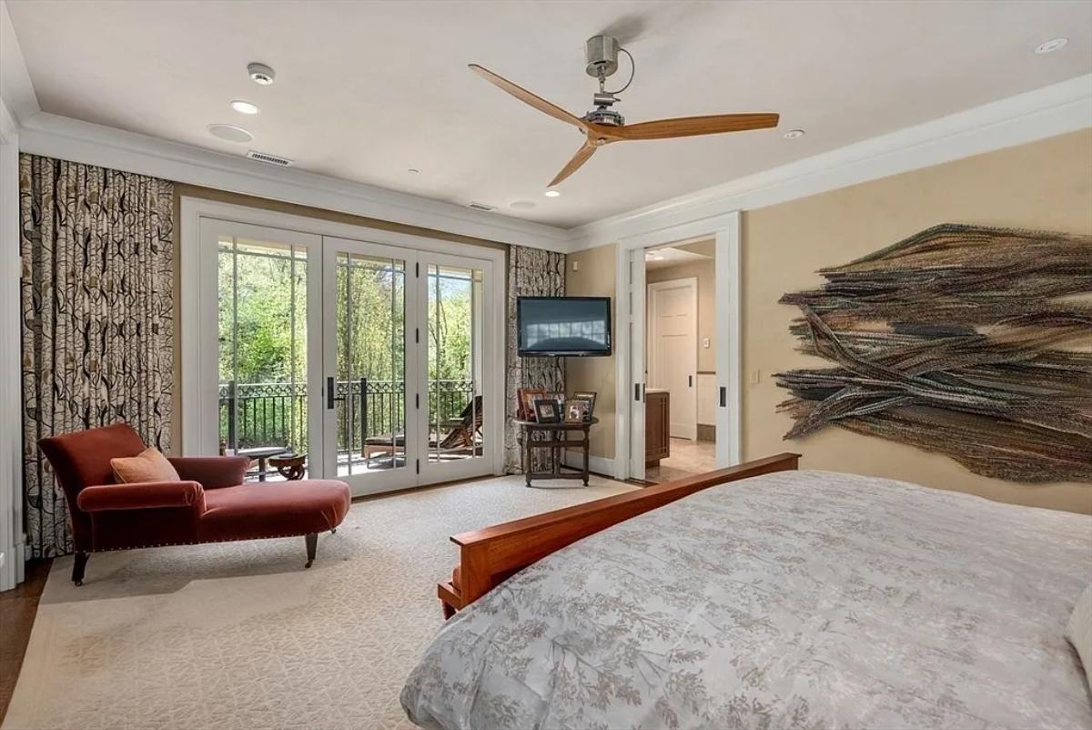 Bedroom with a large bed and glass doors.