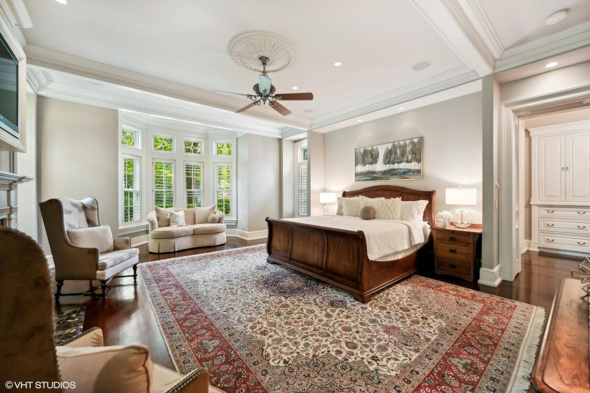 Bedroom with a large bed and hardwood floors.