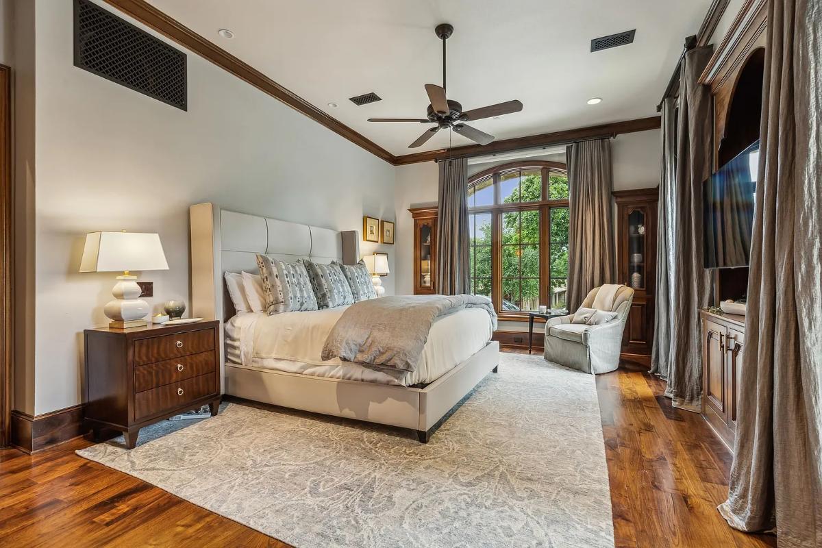 Bedroom with a large bed and hardwood floors.