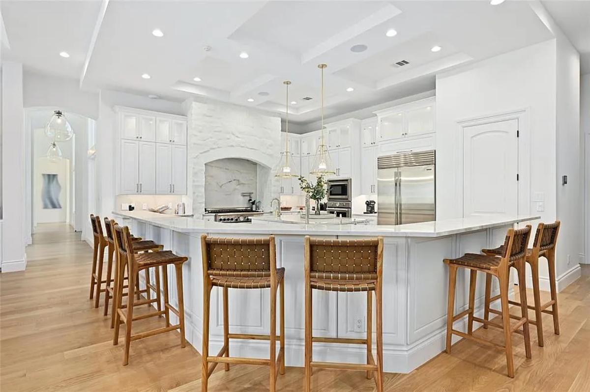 Kitchen with custom cabinetry, a counter breakfast bar and a center island prep area.