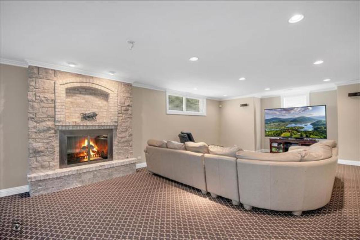 Living room with couches and a fireplace.