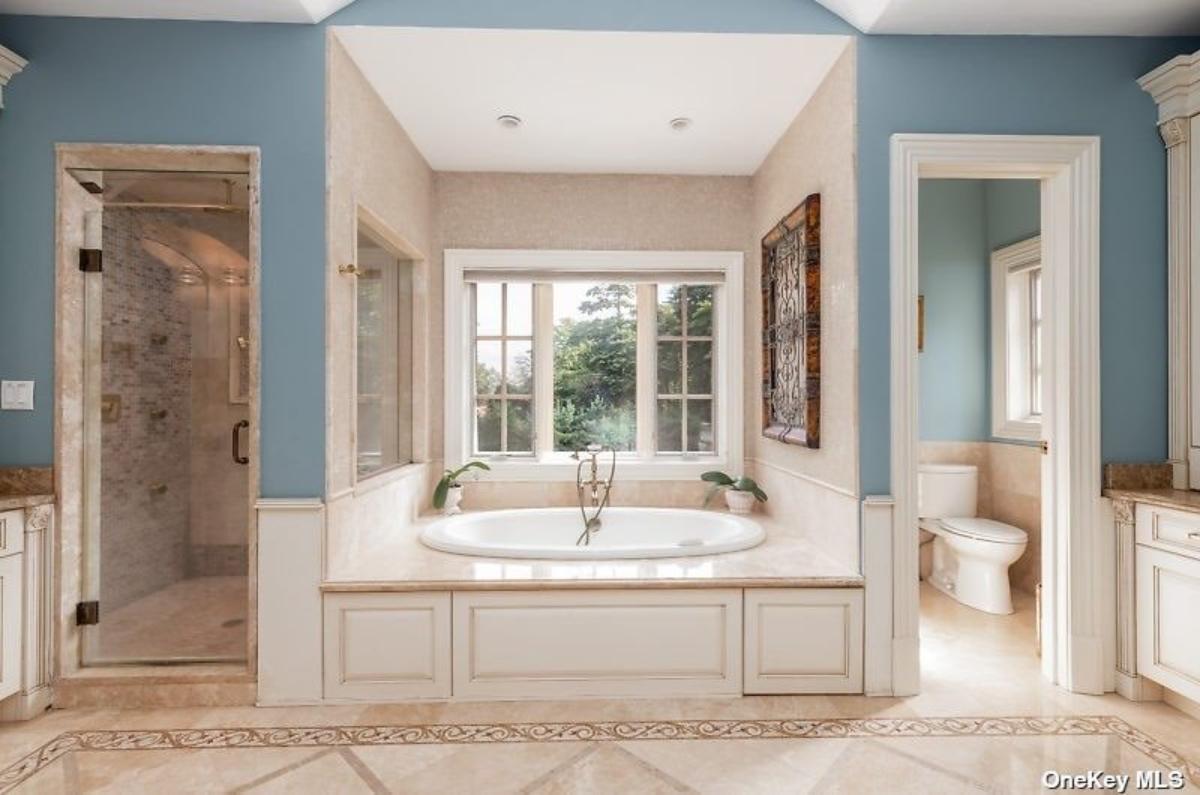 Bathroom with a soaking tub, toilet and a walk-in shower.
